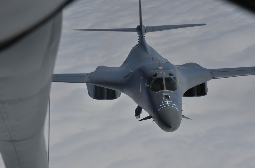 A B-1B Lancer assigned to Ellsworth Air Force Base, South Dakota, trails behind a KC-135 Stratotanker during an aerial refueling training mission Sept. 23, 2014. The B-1B can is the backbone of America's long-range bomber force. It can rapidly deliver massive quantities of precision and non-precision weapons against any adversary, anywhere in the world, at any time. The KC-135 is assigned to Fairchild AFB. (U.S. Air Force photo/Senior Airman Mary O'Dell)