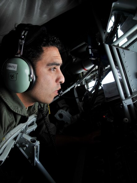 Staff Sgt. Steven Cantu prepares to refuel a B-1B Lancer assigned to Ellsworth Air Force Base, South Dakota, Sept. 23, 2014. Two B-1Bs were refueled by a KC-135 Stratotanker from Fairchild AFB, Washington, during a routine training mission over South Dakota. Nearly all internal fuel can be pumped through the flying boom, the KC-135's primary fuel transfer method. Cantu, a 92nd Air Refueling Squadron boom operator, is stationed in the rear of the plane and controls the boom during in-flight aerial refueling. (U.S. Air Force photo/Senior Airman Mary O'Dell)