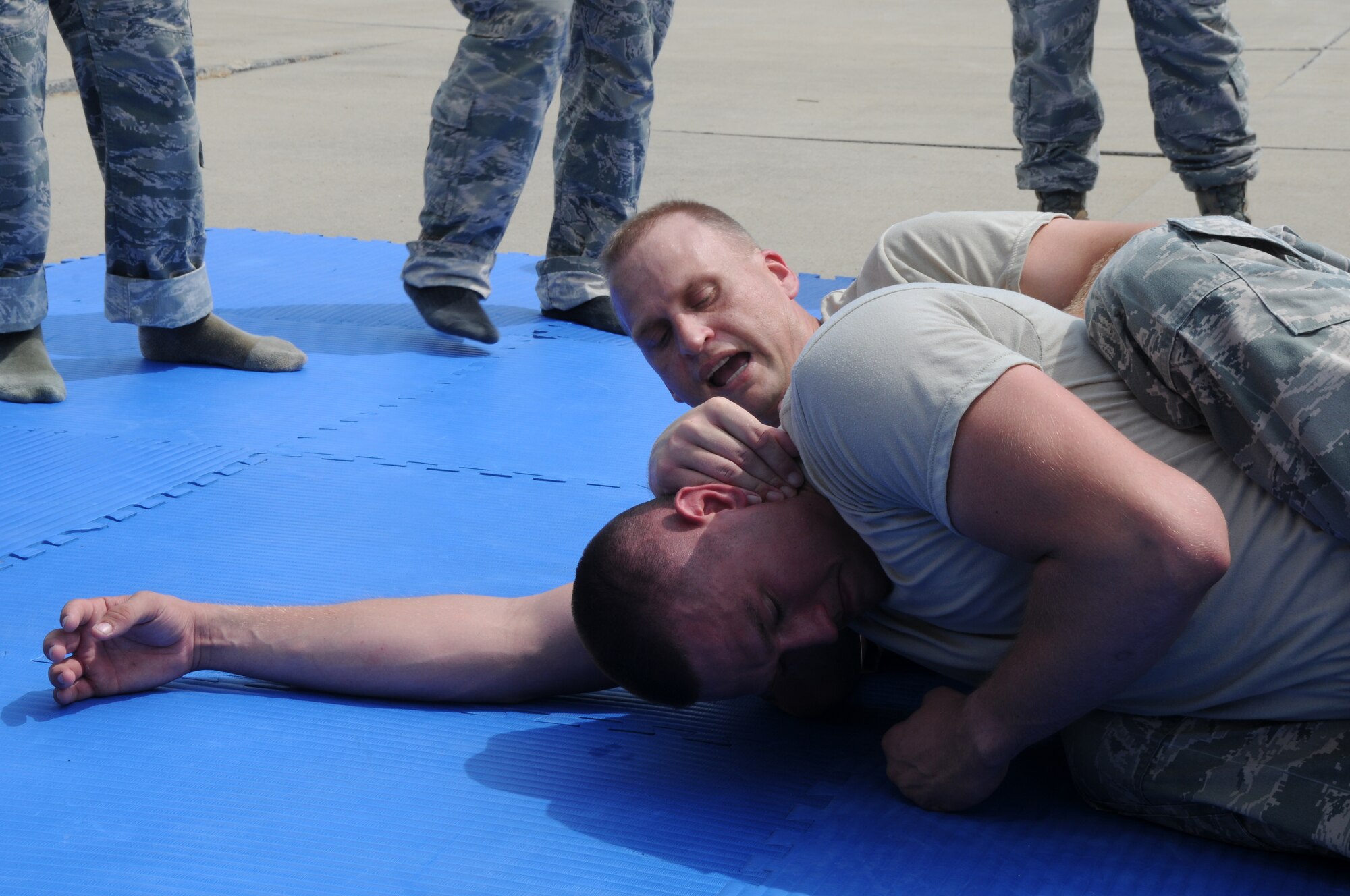 Tech. Sgt. Bradley C. Hobbs and Senior Airman Mason E. Redding show members of the 188th Security Forces Squadron a technique during combative training at Ebbing Air National Guard Base, Fort Smith, Arkansas on Sept. 6, 2014. (U.S. Air National Guard photo by Airman 1st Class Cody Martin/Released)