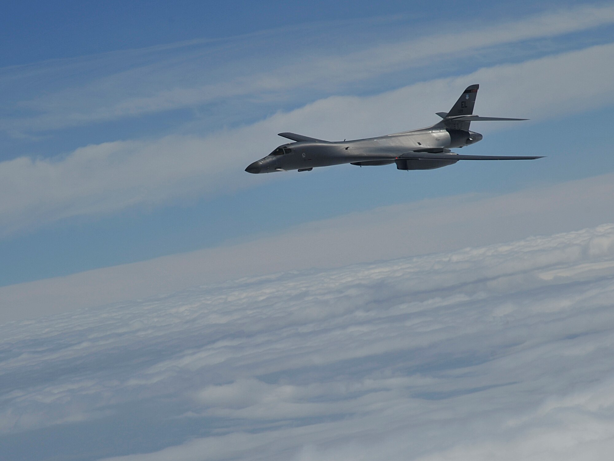 A B-1B Lancer, assigned to Ellsworth Air Force Base, South Dakota, glides through the air over South Dakota, Sept. 23, 2014. Two B-1Bs participated in an aerial refueling training mission with a KC-135 Stratotanker assigned to Fairchild Air Force Base, Washington. The maximum fuel transfer load of the KC-135 is 200,000 pounds. (U.S. Air Force photo by Senior Airman Mary O'Dell/Released)