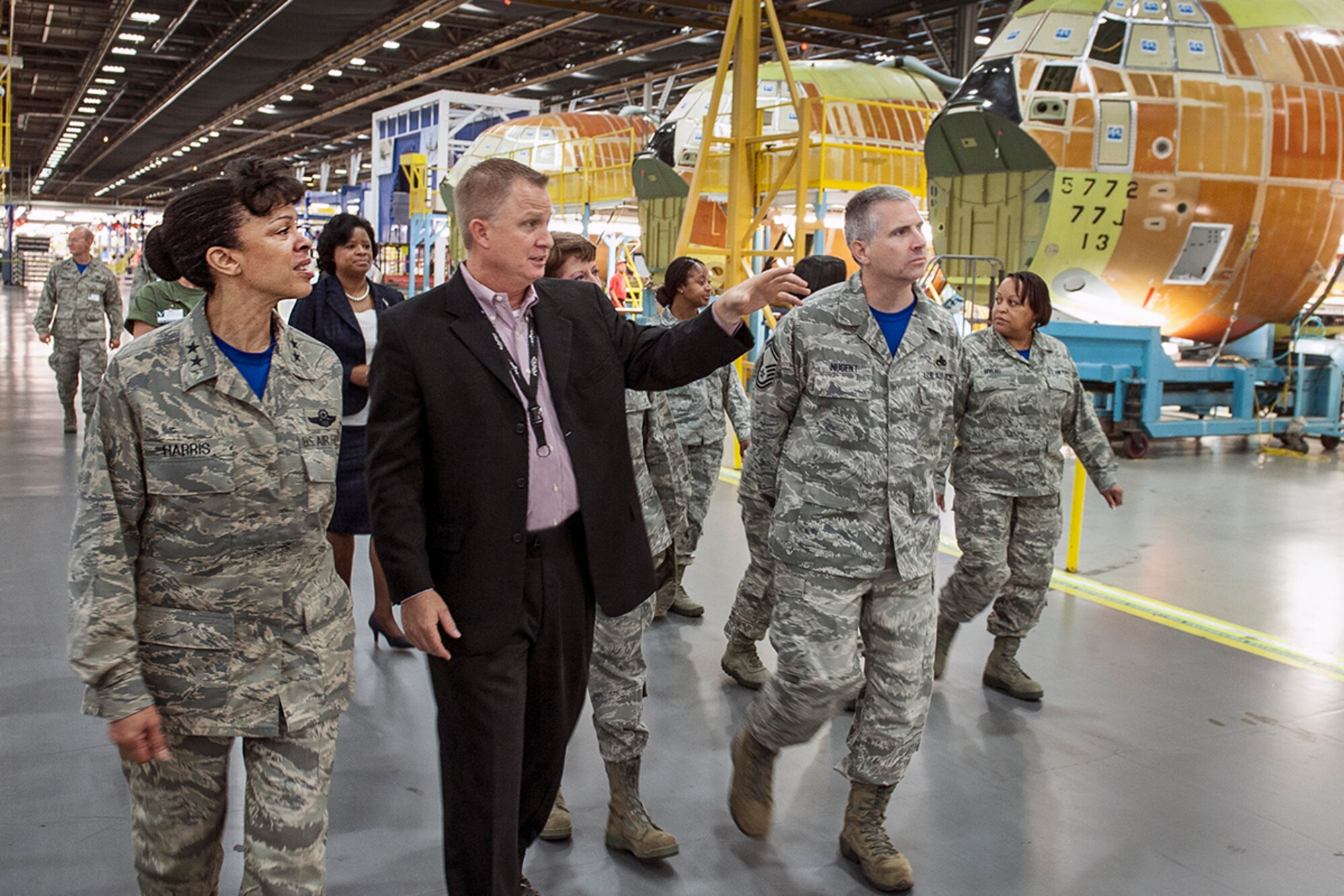 Scott Eads, Lockheed Martin (Plant 6) C-130 director, and Shan Cooper, vice president and general manager, gives Maj. Gen. Stayce Harris, 22nd Air Force commander, and nine unit members a tour of the C-130 production facilities Sept. 19, 2014. Representatives from Lockheed Martin discussed current and future 
programs, as well as its ongoing partnership with Dobbins Air Reserve Base. (Photo by John Rossino)