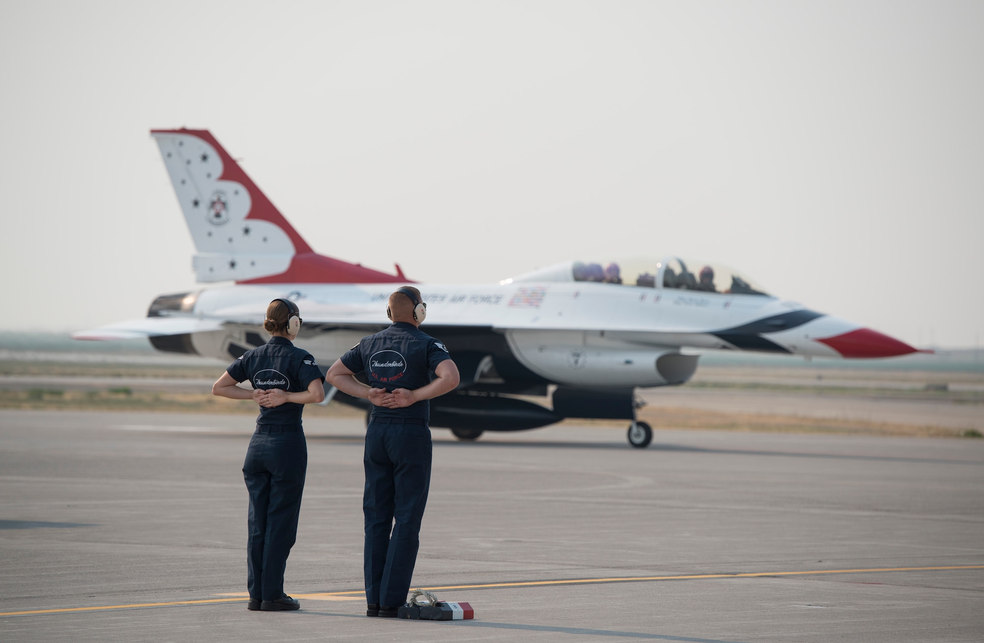 U.S. Air Force Airmen from the U.S. Air Force Air Demonstrations Squadron stand on the flight line Sept. 18, 2014, at Mountain Home Air Force Base, Idaho. The maintainers on the ground are responsible for multiple tasks and ensuring the safety of the pilots and crowd members when it comes game time. (U.S. Air Force photo by Airman 1st Class Brittany A. Chase/Released)