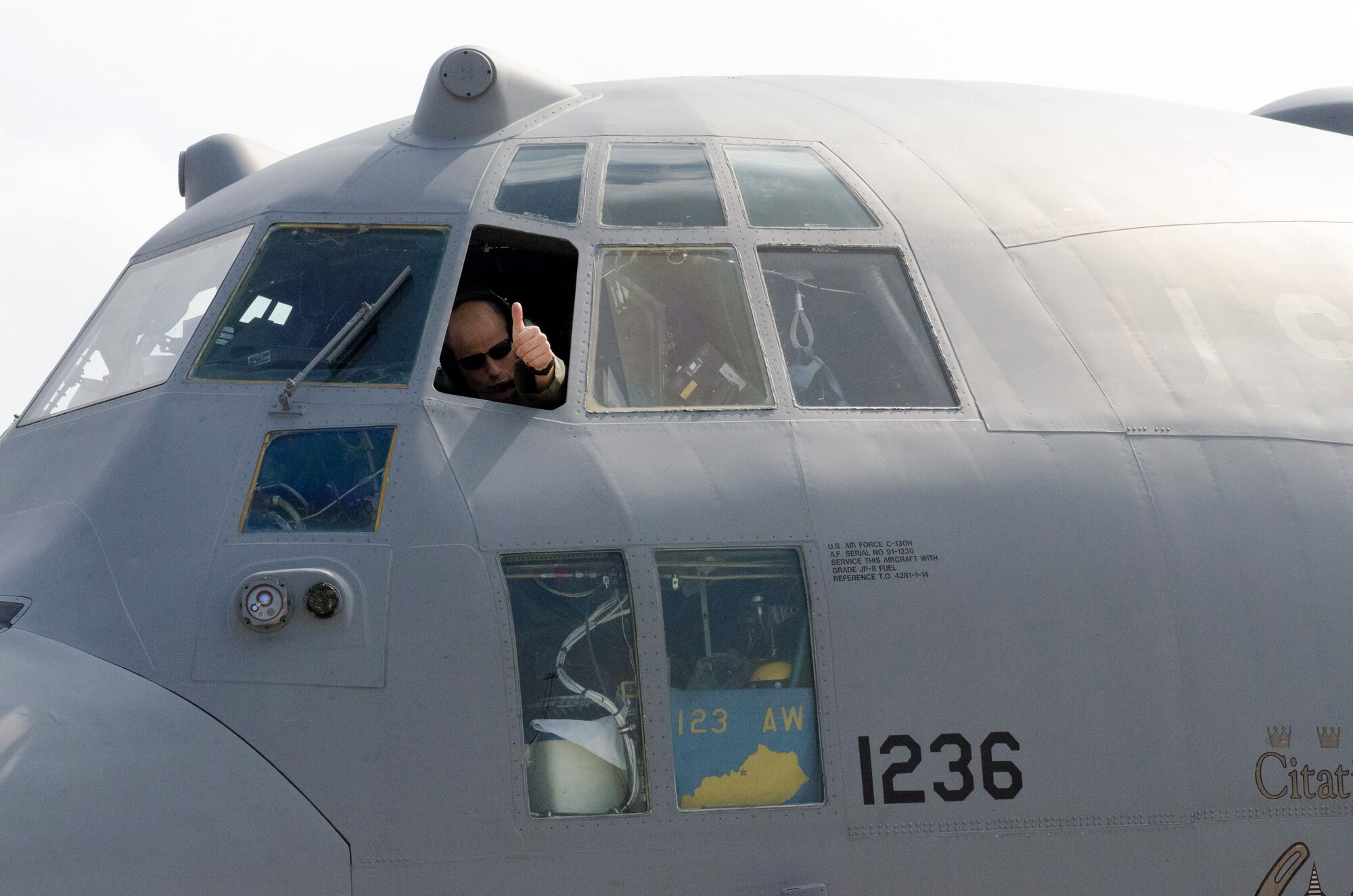 Air Force Lt. Col. Charles Hans, an aircraft commander with the Kentucky Air National Guard’s 123rd Airlift Wing, communicates with ground crews from the cockpit of his C-130 Hercules aircraft after returning from an airdrop mission in the Baltic region on Sept. 8, 2014, during Operation Saber Junction. The 123rd participated in the training exercise along with five other Air Guard units and troops from 17 NATO countries. (U.S. Air National Guard photo by 2nd Lt. James W. Killen)
