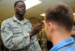 U.S. Air Force Senior Airman Jarret Sanders, 633rd Security Forces Squadron law enforcement official, conducts a field sobriety test during a driving under the influence training exercise at Langley Air Force Base, Va., Sept. 23, 2014. The different personalities of the volunteers gave 633rd SFS Airmen a glimpse at different situations they might encounter on patrol. (U.S. Air Force photo by Senior Airman Austin Harvill/Released)