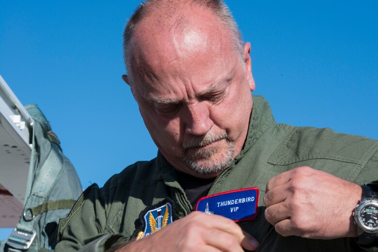 Sergeant David Cavanaugh, Boise police officer, adjusts his uniform before take-off Sept. 19, 2014, at Mountain Home Air Force Base, Idaho. Cavanaugh was chosen as a hometown hero to fly with the U.S. Air Force Thunderbirds. (U.S. Air Force photo by Airman 1st Class Malissa Lott/RELEASED)