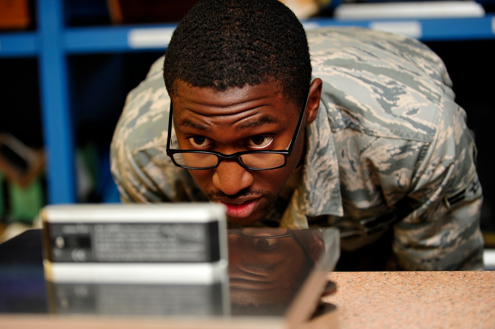 U.S. Air Force Airman 1st Class Xavius Camps, 1st Maintenance Squadron Precision Measurement Equipment Laboratory craftsman uses a leveling tool to make sure a plate is flat at Langley Air Force Base, Va., Sept. 23, 2014. PMEL technicians ensure accuracy and tolerance of intricate electronic and physical dimensional test equipment used throughout the lab. (U.S. Air Force photo by Airman 1st Class Breonna Veal) 