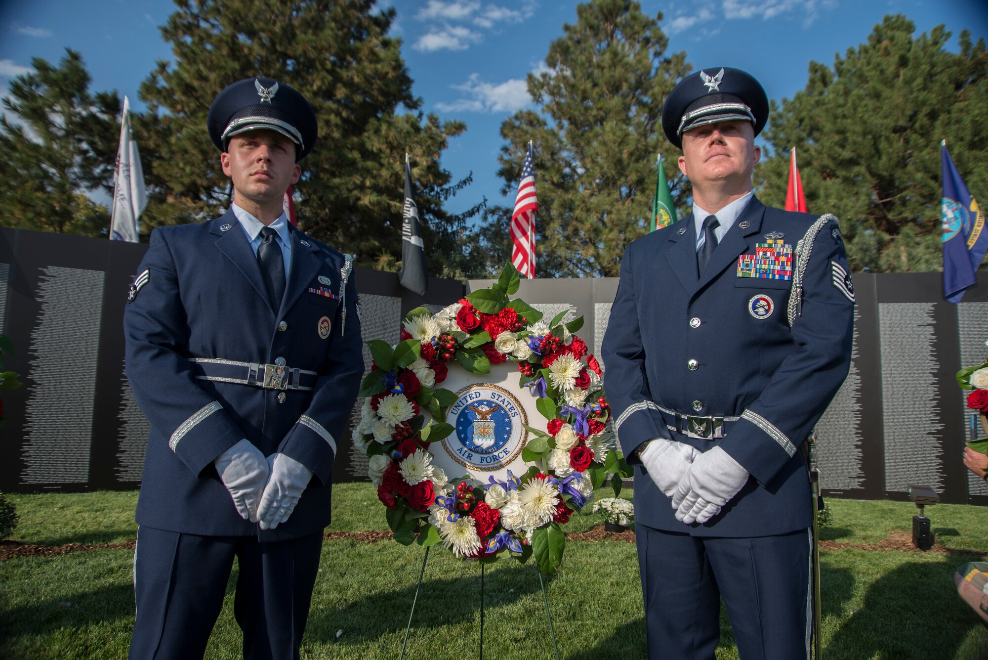 Senior Airman Alexander Young, 726th Air Control Squadron materials control journeyman, and Tech. Sgt. Patrick Mackey, NCO in charge of the Honor Guard, represent the Air Force during a wreath laying ceremony to pay tribute to The Traveling Wall in Boise, Idaho, Sept. 18, 2014. American Veterans Traveling Tribute and Texas Freedom Tribute joined forces to travel the United States bringing the Cost of Freedom Tribute and The Traveling Wall to American communities. Each tribute will have the opportunity to establish a unique event centered on patriotism and the American spirit while being able to raise funds to support local causes. (U.S. Air Force photo by Staff. Sgt. Roy Lynch III/RELEASED)