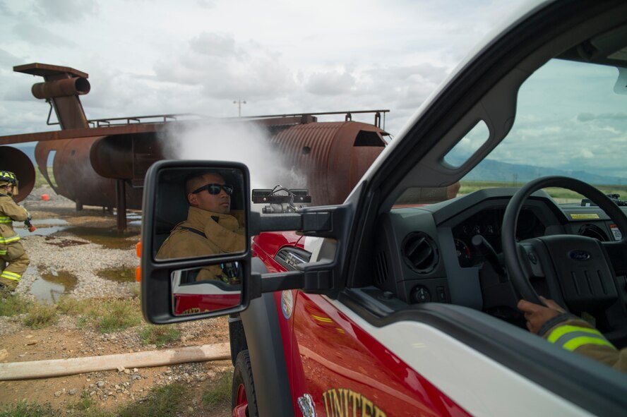 Senior Airman Jason Piol, 49th Civil Engineer Squadron Fire Protection Flight firefighter, extinguishes a simulated fire using the ultra-high pressure turret mounted on the P-34 Rapid Intervention Vehicle at Holloman Air Force Base, N.M., Sept. 21. The RIV is three times more cost effective than the conventional firefighting vehicles. The combination of water and firefighting foam discharges at 1,350 pounds per square inch and increases the length of time that the RIV can remain on scene without having to be resupplied. Even though the RIV has a smaller capacity of 500 gallons, it has the firefighting capability of the larger 1,500 to 1,750 gallon vehicle at a cost that is significantly less. (U.S. Air Force photo by Airman 1st Class Aaron Montoya / Released)