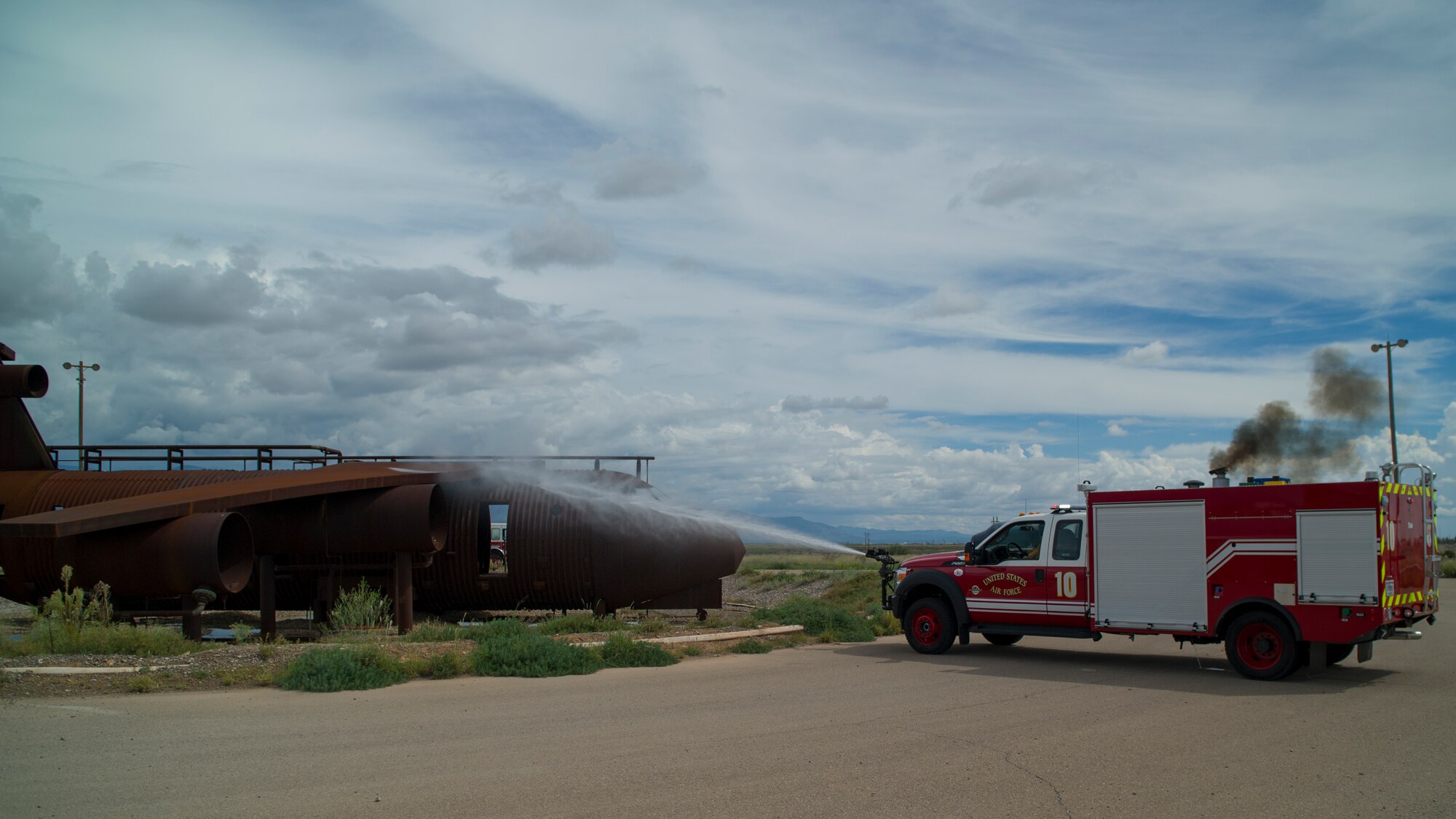 Members of the 49th Civil Engineer Squadron Fire Protection Flight perform an exercise highlighting the capabilities of their new P-34 Rapid Intervention Vehicle at Holloman Air Force Base, N.M., Sept. 21. The RIV is three times more cost effective than the conventional firefighting vehicles. The combination of water and firefighting foam discharges at 1,350 pounds per square inch and increases the length of time that the RIV can remain on scene without having to be resupplied. Even though the RIV has a smaller capacity of 500 gallons, it has the firefighting capability of the larger 1,500 to 1,750 gallon vehicle at a cost that is significantly less. (U.S. Air Force photo by Airman 1st Class Aaron Montoya / Released) 