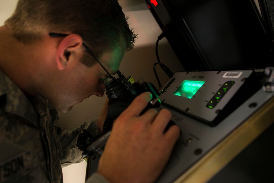 U.S. Air Force Senior Airman Mason Bengtson, 38th Rescue Squadron aircrew flight equipment journeyman, checks the accuracy of night vision goggles Sept. 23, 2014, at Moody Air Force Base, Ga. The 38th RQS pararescuemen use durably built night vision goggles for combat operations. (U.S. Air Force photo by Airman 1st Class Dillian Bamman/Released)