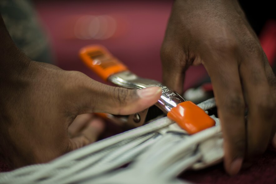 A heavy-duty clip holds parachute strings together during a packing inspection Sept. 23, 2014, at Moody Air Force Base, Ga. The clip holds parachute lines together during in-depth inspections and parachute packing. (U.S. Air Force photo by Airman 1st Class Dillian Bamman/Released)