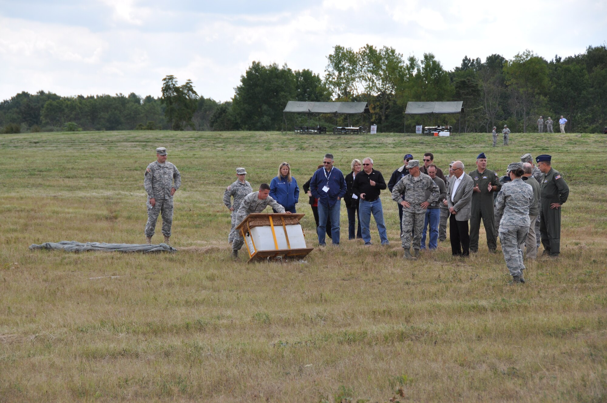 Honorary Commanders are briefed by members of the 911th Airlift Wing after a cargo drop is performed by two C-130’s demonstrating the skill and effectiveness of the wing’s air crew’s at Burgettstown, Pa., Sept.  17, 2014. The Honorary Commander’s event is a gathering of local business leaders who take an active role in utilizing the Employer Support of the Guard and Reserve to hire veterans and also use the ESGR to help resolve any conflicts that may arise from an employee’s military commitment. The event was held to showcase the skills and professionalism of Guardsmen and Reservists for local business leaders and also give a glimpse of what goes into a service member’s military commitment. (U.S. Air Force photo by Senior Airman Joseph E. Bridge)