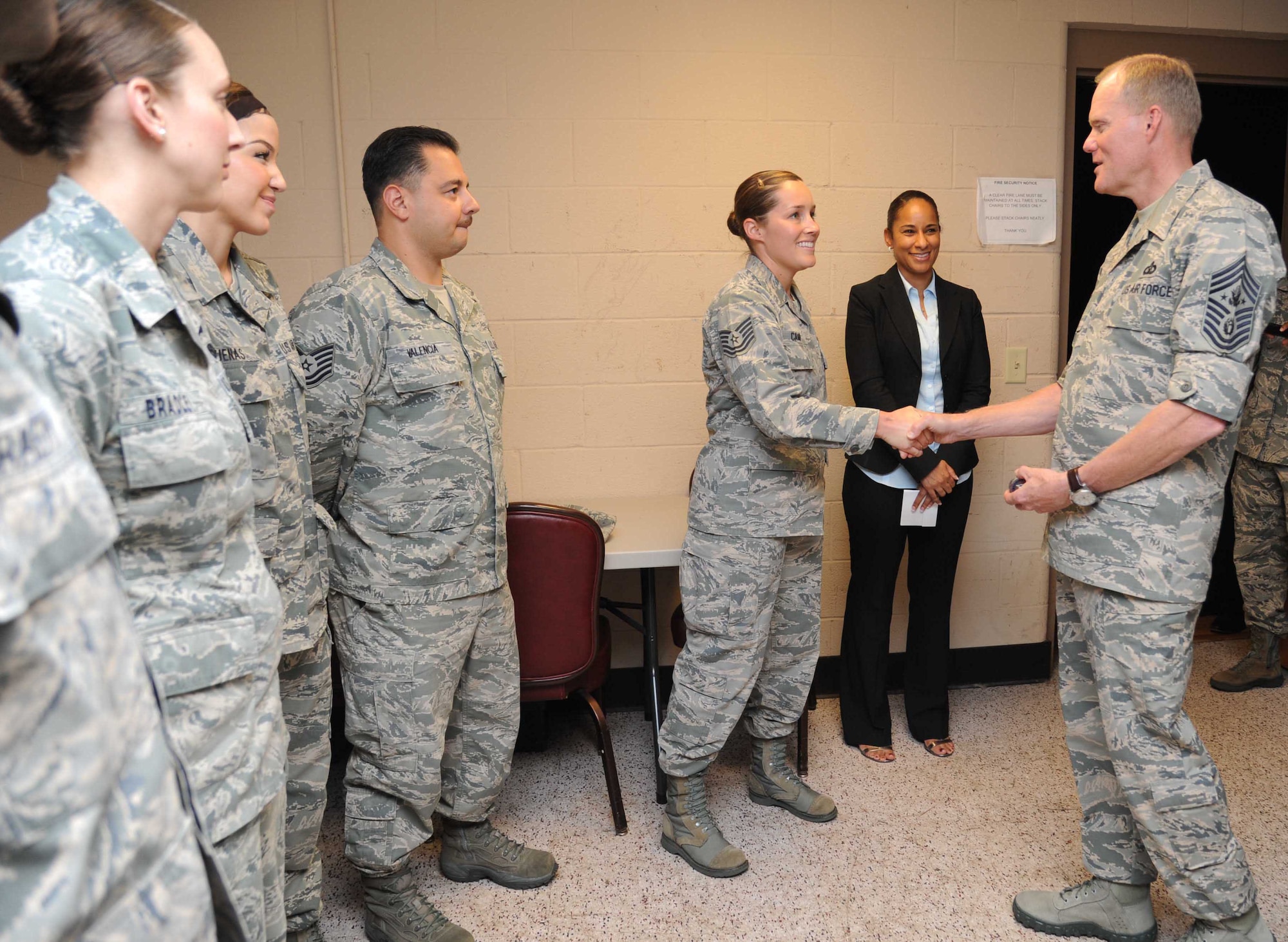 Chief Master Sgt. of the Air Force James A. Cody recognizes Tech. Sgt. Christina Camp, 334th Training Squadron, with a coin as her supervisor, Desirae McIntyre, stands by at the Welch Theater during a two-day visit of Keesler Air Force Base, Miss., Sept. 22-23, 2014.  The purpose of the visit was to thank Team Keesler members and further understand the various missions here, including 2nd Air Force, 81st Training Wing and the 403rd Wing. (U.S. Air Force photo by Kemberly Groue)