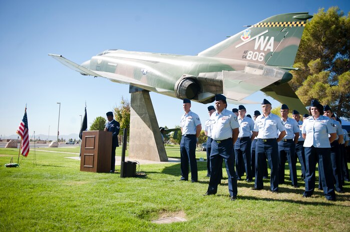 Airmen from Nellis and Creech Air Force Bases and the Nevada Test and Training stand in formation during the Prisoner of War and Missing in Action Recognition Ceremony at Nellis Air Force Base, Nev., Sept. 19, 2014. These Airmen volunteered to stand in formation throughout the  ceremony to commemorate and honor U.S. military members who have been POWs or are still MIA. (U.S. Air Force photo by Airman 1st Class Mikaley Towle)