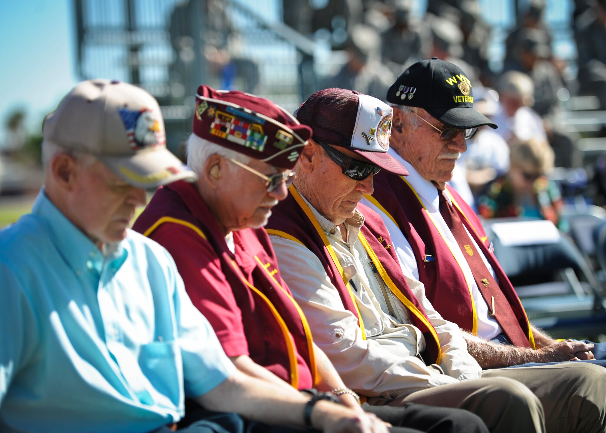 U.S. Armed Forces veterans bow their heads in remembrance during the Prisoner of War and Missing in Action Recognition Ceremony at Nellis Air Force Base, Nev., Sept. 19, 2014. During the ceremony, service members were honored for their commitment and service to the nation during their time spent as POWs. (U.S. Air Force photo by Staff Sgt. Siuta B. Ika)