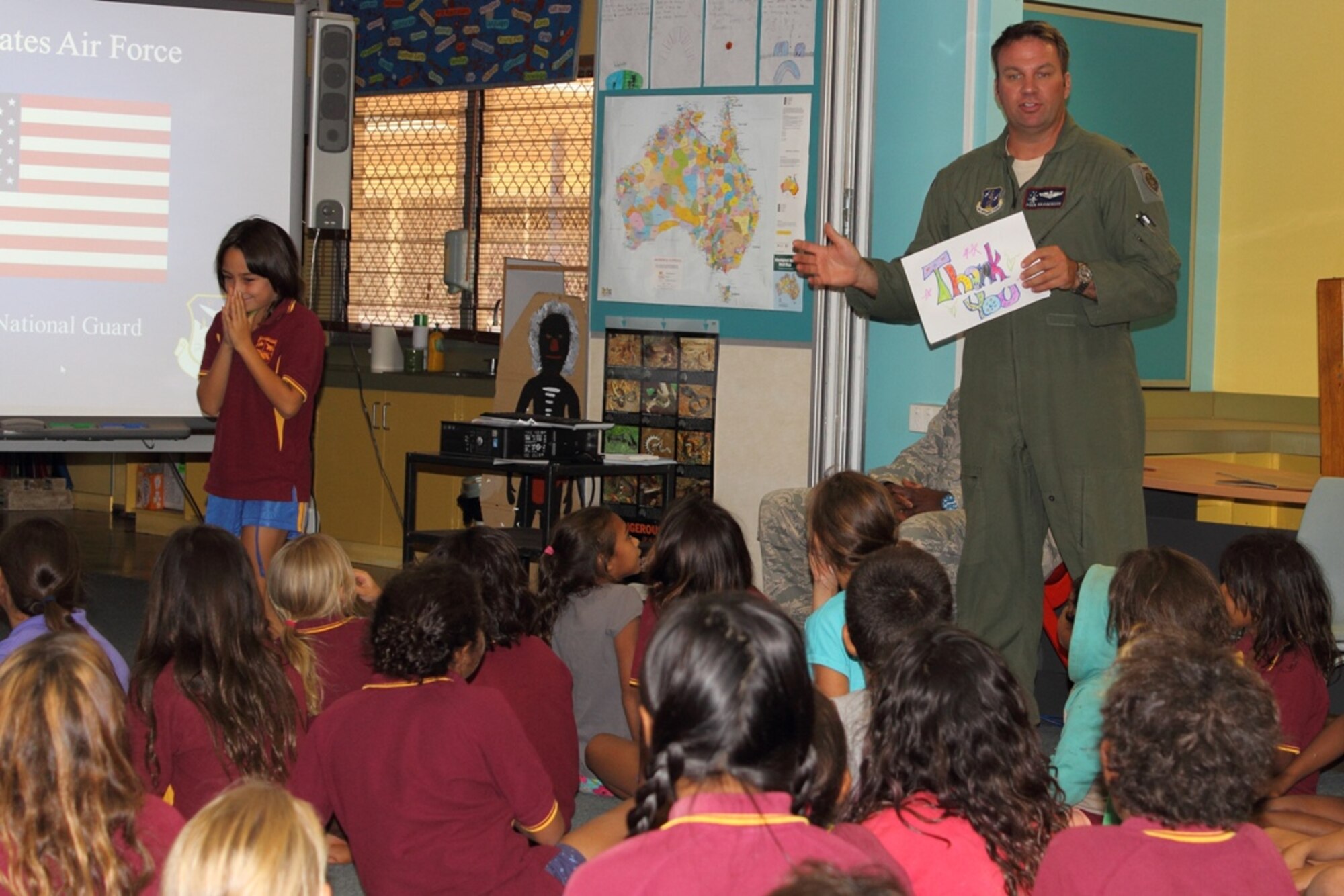 Lt. Col. Eric Haagenson, pilot, 113th Wing, D.C. Air National Guard, accepts a thank-you note from Australian primary school students at McFarlane Primary School in Katherine, Australia, during the unit's visit, Sept. 17.  (U.S. Air National Guard photo/Airman 1st Class Aaron Church)