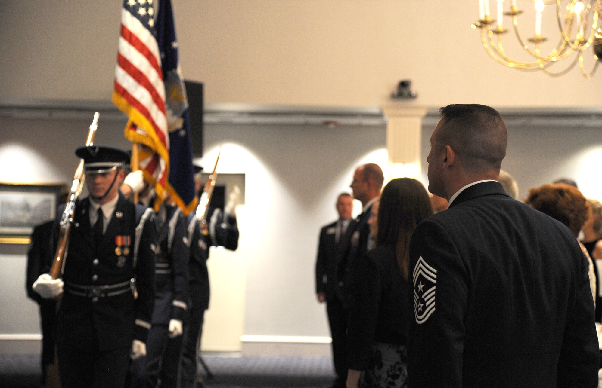 Joint Base Andrews Command Chief Master Sgt. Vance Kondon stands at attention as Airmen from the U.S. Air Force Honor Guard present the colors during the Air Force District of Washington Air Force Birthday Ball at Joint Base Anacostia-Bolling, Washington, D.C., Sept. 19, 2014. The Air Force’s 67th birthday served as an opportunity for Airmen to celebrate the force’s history, heritage, and culture while building esprit de corps. (U.S. Air Force photo/Master Sgt. Tammie Moore) 