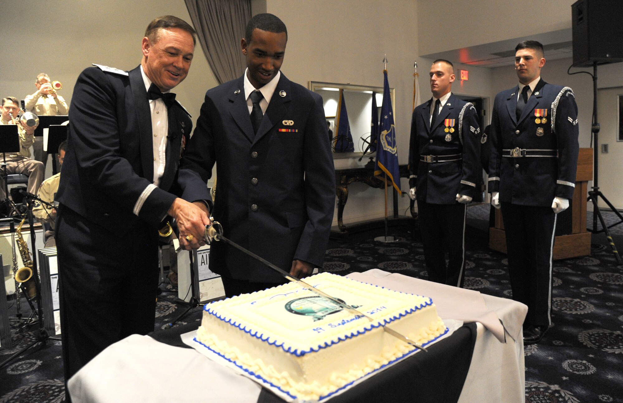 Air Force District of Washington Commander Maj. Gen. Darryl Burke and Airman Jabari Wright cut the Air Force birthday cake during the AFDW Air Force Birthday Ball at Joint Base Anacostia-Bolling, Washington, D.C., Sept. 19, 2014. Wright, the youngest Airman to attend the Air Force ball, is assigned to the 844th Communications Group. (U.S. Air Force photo/Master Sgt. Tammie Moore)