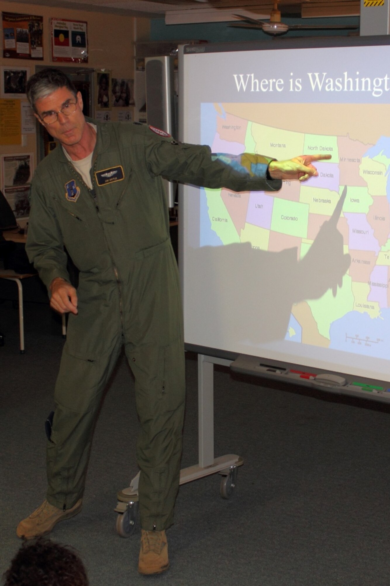 Flight surgeon Lt. Col. Jim Doyle tells Australian youngsters about the District of Columbia Air National Guard's home city with a short geography lesson on a visit to McFarlane Primary School, near the unit's deployed location at RAAF Tindal, Australia, Sept. 17. (U.S. Air National Guard photo/Airman 1st Class Aaron Church)