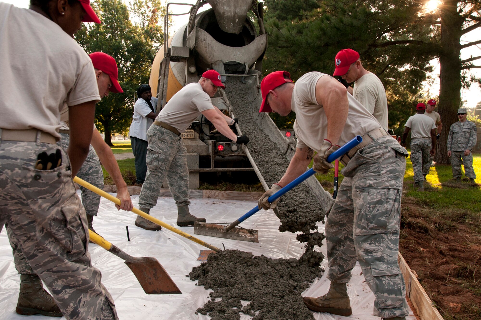 Members of the 307th RED HORSE pour concrete at Barksdale Air Force Base, La., Sept. 9, 2014. A total of four slabs were poured, three for new athletic equipment along one of the running trails and one for parking at the 93rd Bomb Squadron building. (U.S. Air Force photo by Master Sgt. Jeff Walston/Released)