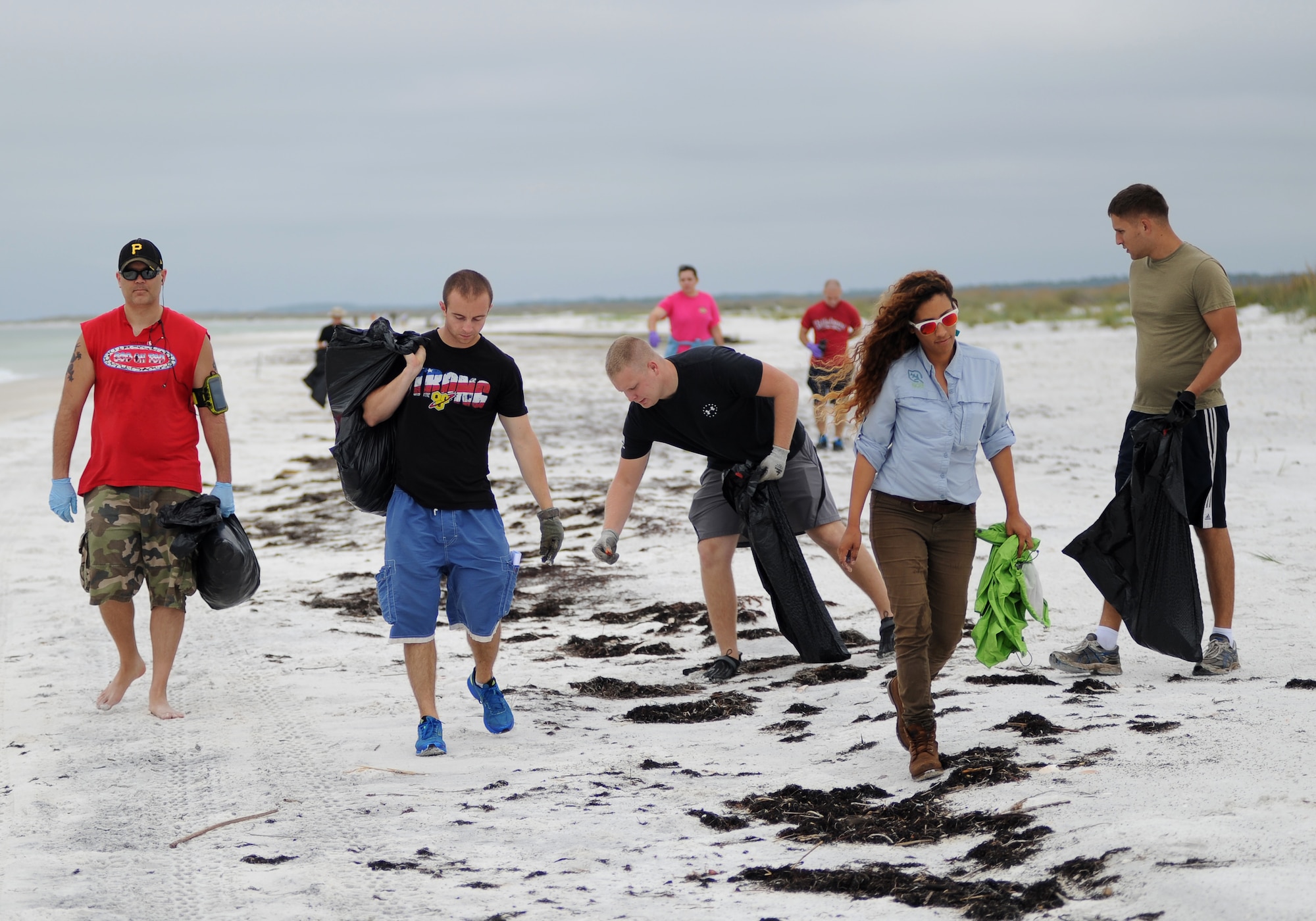 Volunteers comb the beach looking for trash during the 29th Annual International Coastal Cleanup Sept. 20. Over 175 members of Team Tyndall joined the Society of American Military Engineers and the 325th Civil Engineering Squadron to rid the base’s beaches of debris. (U.S. Air Force photo by Airman 1st Class Alex Echols)