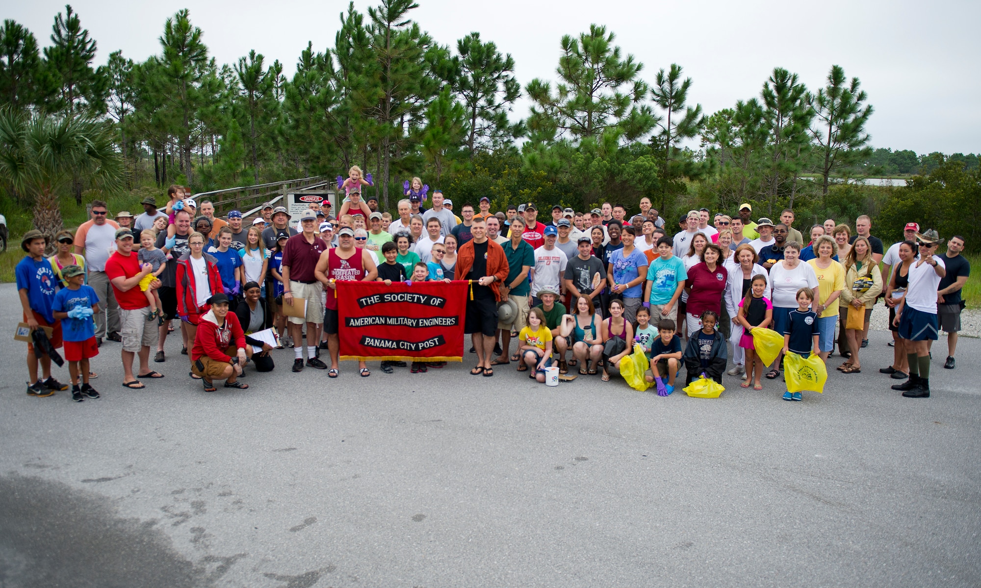Volunteers pose for a group photo Sept. 20 at the NCO beach boardwalk. Over 175 members of Team Tyndall joined the Society of American Military Engineers and the 325th Civil Engineering Squadron to rid the base’s beaches of trash during the 29th Annual International Coastal Cleanup. (U.S. Air Force photo by Airman 1st Class Alex Echols)