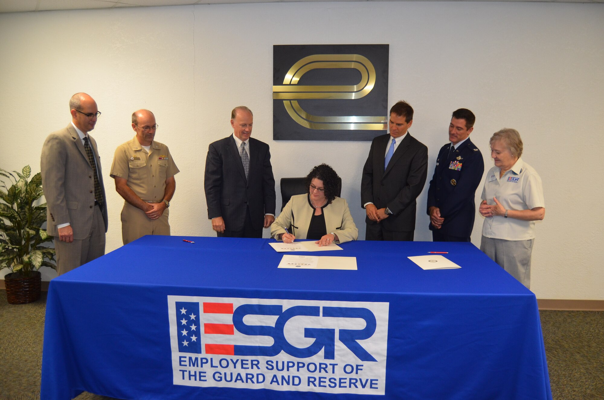Enterprise Holdings, Inc. (Texas) Group Truck Rental Manager Angela Thatcher (sitting) signs an Employer Support of Guard and Reserve Statement of Support on September 17, 2014 in San Antonio, Texas with (from left to right) Jeffrey Downing, Group Human Resources manager, Capt. Steve Brown, Naval Operations Support Center- San Antonio commander, Bill Gold, Vice President/General Manager, Victor Citron, Group Rental manager, Col. Bill Whittenberger, Jr. and Caryl Hill, Texas Committee ESGR San Antonio chair, observe the event. (U.S. Air Force Photo/Maj. Tim Wade)