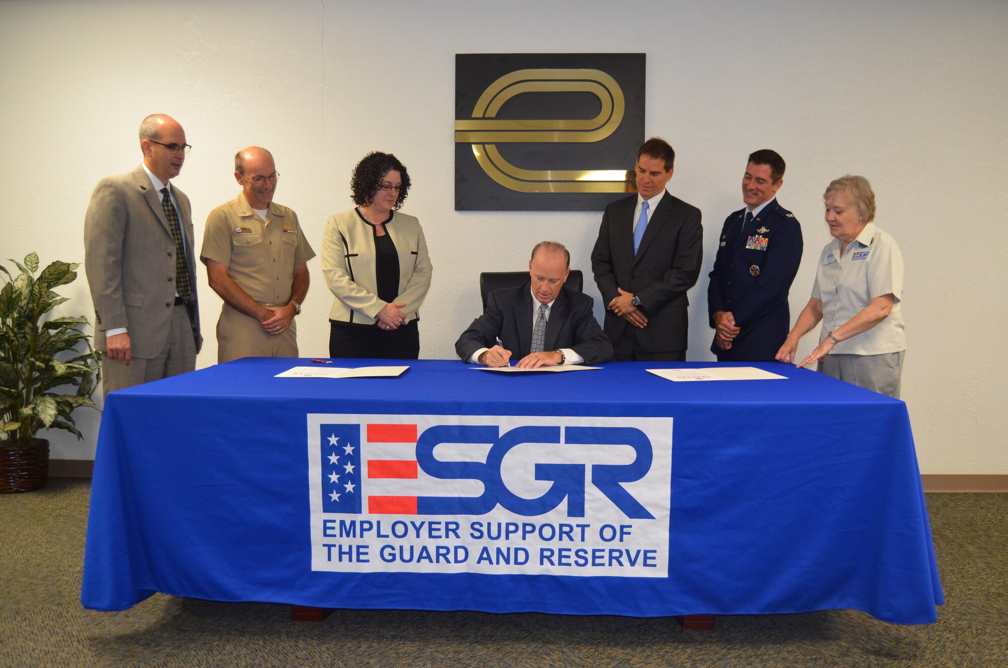 Enterprise Holdings, Inc. (Texas) Vice President/General Manager Bill Gold (sitting) signs an Employer Support of Guard and Reserve Statement of Support on September 17, 2014 in San Antonio, Texas with (from left to right) Jeffrey Downing, Group Human Resources manager, Capt. Steve Brown, Naval Operations Support Center- San Antonio commander, Angela Thatcher, Group Truck Rental manager, Victor Citron, Group Rental manager, Col. Bill Whittenberger, Jr. and Caryl Hill, Texas Committee ESGR San Antonio chair, observe the event. (U.S. Air Force Photo/Maj. Tim Wade)