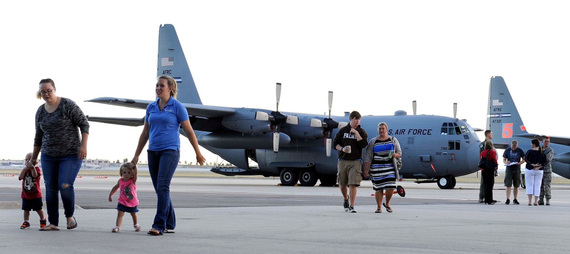 Families walk away from a static display of a C-130 after going inside to see what it looks like at the Deployed Families’ Dinner held in Hangar 210 on Sept. 19. The Deployed Families’ Dinner is held once a month for families to get together and have a little fun and a support system while their loved ones are overseas. (U.S. Air Force photo/Airman 1st Class Rose Gudex)