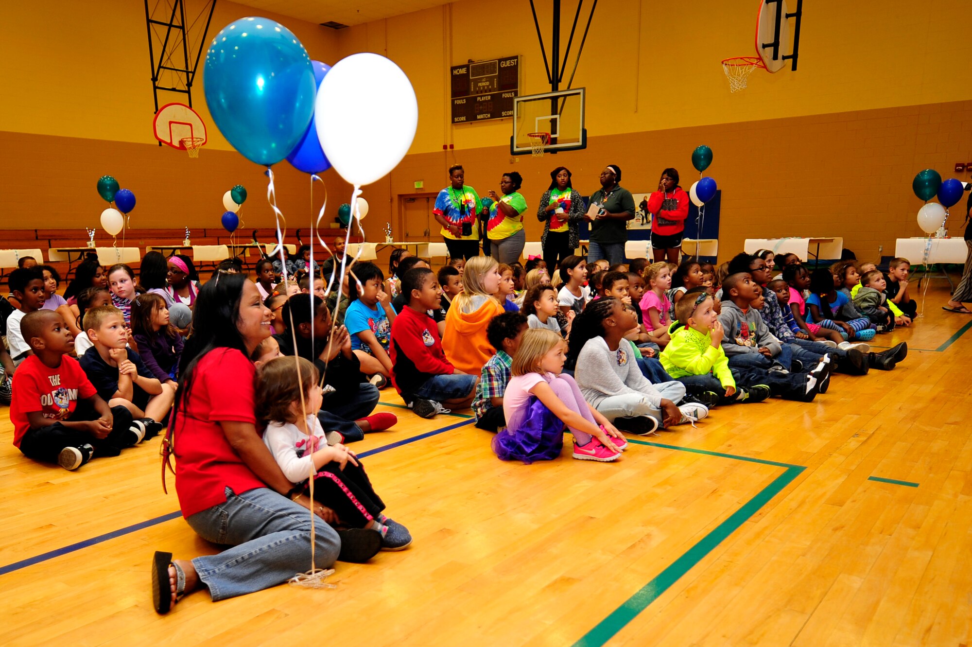 Children of U.S. Service members listen to Disney on Ice performers talk to them at the Bethel Manor Youth Center in Hampton, Va., Sept. 23, 2014. The USO sponsors events throughout the year to enhance morale amongst families. (U.S. Air Force photo by Airman 1st Class Breonna Veal) 