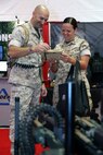 Capt Brad Goldvarg shows a young Marine how simple the Tactical Robotic Controller is to use. The TRC can control a variety of unmanned aircraft systems, unmanned ground systems, and sensors.