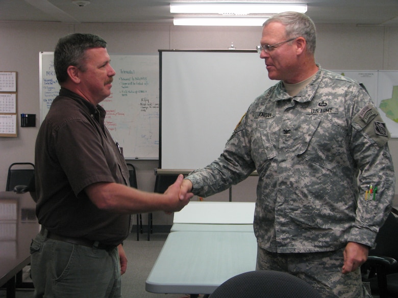 Col Jordan presents Jeff McMaster with a Baltimore District coin for his Hero of the Year selection.
