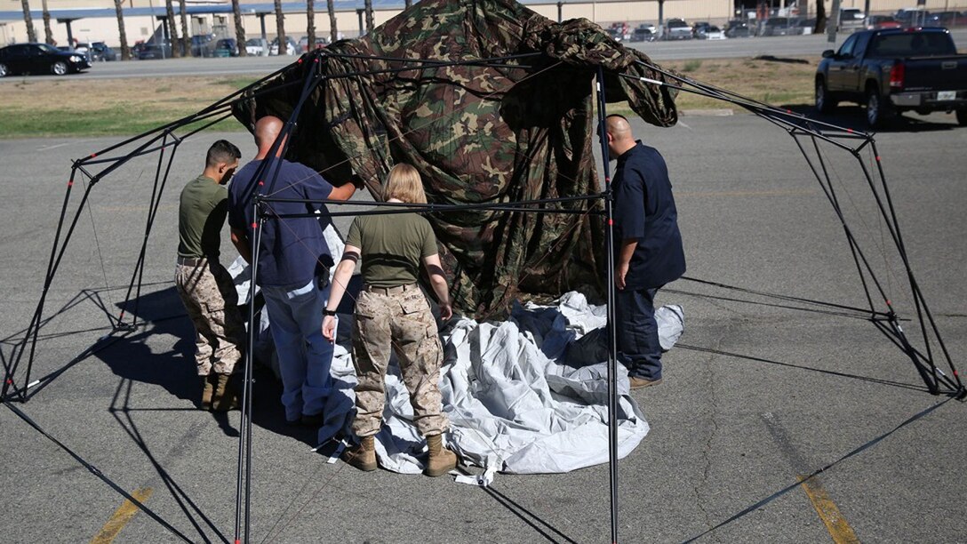 Marines and civilian contractors put together an Arctic shelter Aug. 29, 2014, aboard Camp Pendleton, California. The system is an ultra-lightweight, rapidly deployable shelter that offers military forces the necessary infrastructure to operate in austere cold-weather locations. The system is being used for training exercises in Bridgeport, California, and is slated to be integrated into exercises early next year.