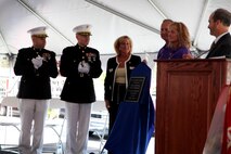 COTTLEVILLE, MO – Julie and David Vinnedge are presented a plaque dedicating the Cottleville Post Office in memory of their son Lance Cpl. Phillip Vinnedge in Cottleville Sept. 23. Lance Cpl. Vinnedge was an Anti-tank Assaultman with 3rd Battalion, 5th Marine Regiment deployed to Helmand Provence, Afghanistan in 2010 when his vehicle was struck by an improvised explosive device on October 13, 2010. Also in the vehicle with Vinnedge were Cpl. Justin J. Cain, Lance Cpl. Joseph E. Rodewald and Pfc. Victor A. Drew. (U.S. Marine Corps photo by Sgt. Erik S. Brooks Jr.)  