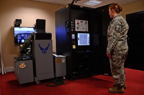 Master Sgt. Virginia McDonough assists a pilot from the 100th Operations Group during simulated hypoxia training Sept. 17, 2014, at Royal Air Force Station Lakenheath, England. Hypoxia is a condition in which the tissues of the body don’t receive enough oxygen, causing loss of consciousness. Hypoxia training helps pilots recognize the signs and symptoms of the condition and teaches them how to avoid it before encountering the adverse effects. McDonough is the 48th Aerospace Medical Squadron flight chief of operational physiology. (U.S. Air Force photo/Airman 1st Class Erin O’Shea)