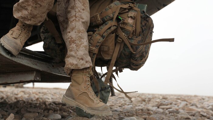 A Marine wearing Rugged All Terrain boots disembarks from a helicopter in Afghanistan. Two pairs of RAT boots, a temperate variant and hot variant, like the ones pictured above, will be issued to Marine Corps recruits and officer candidates in their sea bags starting Dec. 1, 2014.