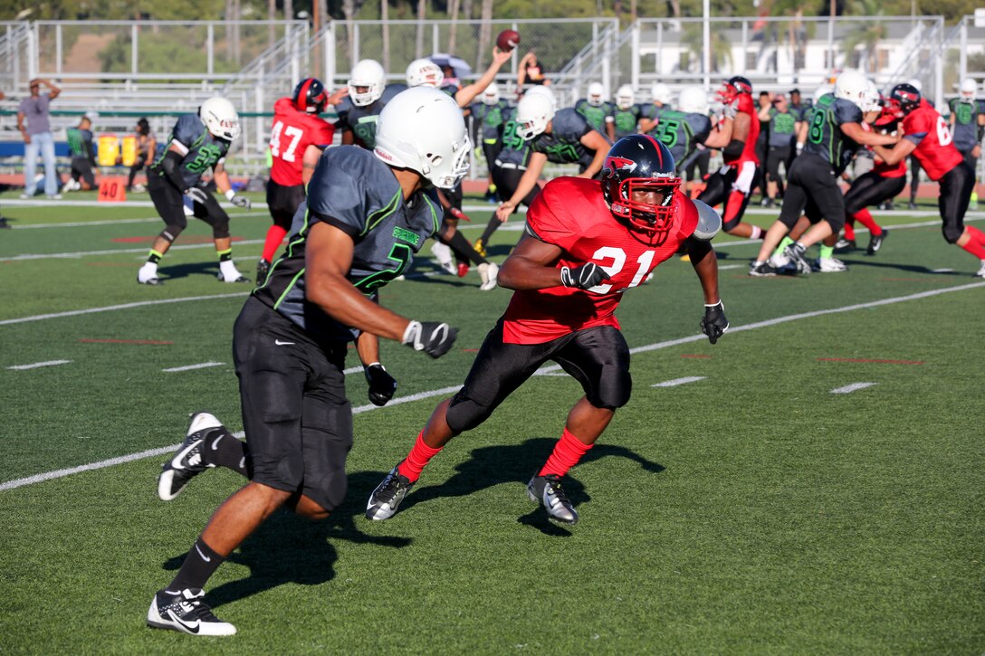 Elvis Liburd, right, a Marine Corps Air Station Miramar Falcons’ defensive back, covers a Marine Corps Base Camp Pendleton Headquarters Support Battalion Spartan during a football game at Paige Field House aboard MCB Camp Pendleton, Calif., Sept. 23. The Falcons lost with a final score of 36-0.