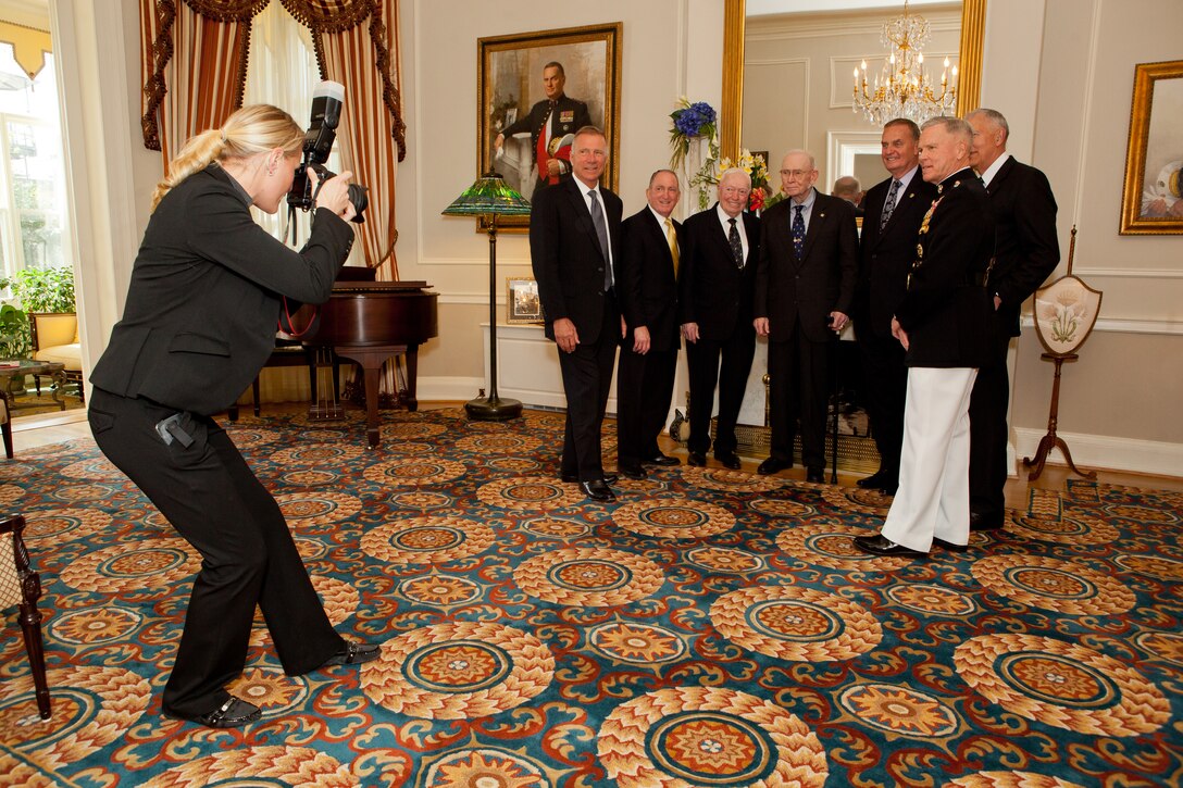 From left, U.S. Marine Corps Sgt. Mallory VanderSchans, a combat camera photographer, photographs Michael W. Hagee, Charles C. Krulak, Alfred M. Gray Jr., Paul X. Kelley, James L. Jones and James T. Conway, all former commandants of the Marine Corps, and Commandant of the Marine Corps Gen. James F. Amos during a reception for friends and family following a memorial service for former Commandant of the Marine Corps Gen. Carl E. Mundy Jr. April 12, 2014, at the Home of the Commandants at Marine Barracks Washington in Washington, D.C. Mundy served as commandant from 1991 to 1995. (U.S. Marine Corps photo by Cpl. Tia Dufour/Released)