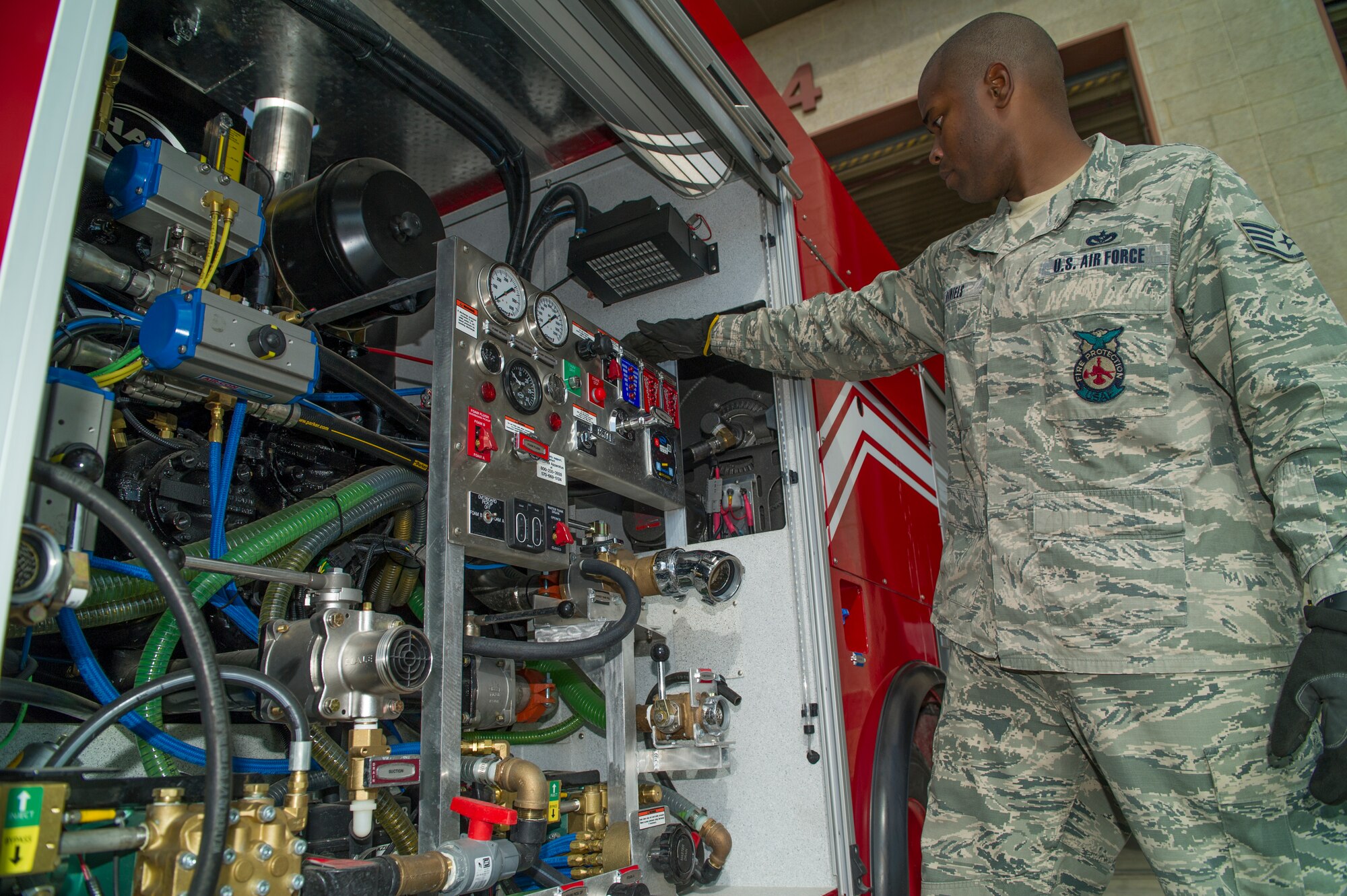 Staff Sgt. Phillip Daniels, 49th Civil Engineer Squadron Fire Protection Flight firefighter, performs routine user maintenance on the new P-34 Rapid Intervention Vehicle at Holloman Air Force Base, N.M., Sept. 21, 2014.. The RIV is three times more cost effective than the conventional firefighting vehicles. The combination of water and firefighting foam discharges at 1,350 pounds per square inch and increases the length of time that the RIV can remain on scene without having to be resupplied. (U.S. Air Force photo by Airman 1st Class Aaron Montoya) 