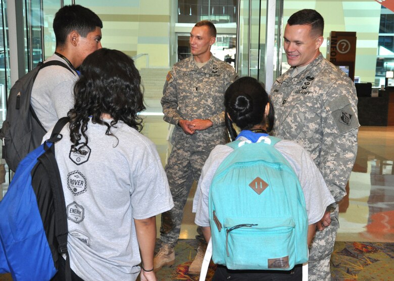 Capt. Adam Z. McGinnis, the U.S. Army Corps of Engineers Los Angeles District’s deputy area engineer for the Arizona-Nevada Area Office, and 1st Lt. Luke Ritz, a project engineer at the District’s Fort Huachuca office, speak with a group of students from Phoenix area schools during a Science Technology Education and Math event held Sept. 25 at the Phoenix Convention Center by Ten80 Education. The event was one of ten expositions Ten80 held across the country in 2014 where students actively engage in workshops, demonstrations and a one-day points race for pride and prizes and both students and teachers could evaluate the National STEM League curriculum, collaborative network and optional competition league. 