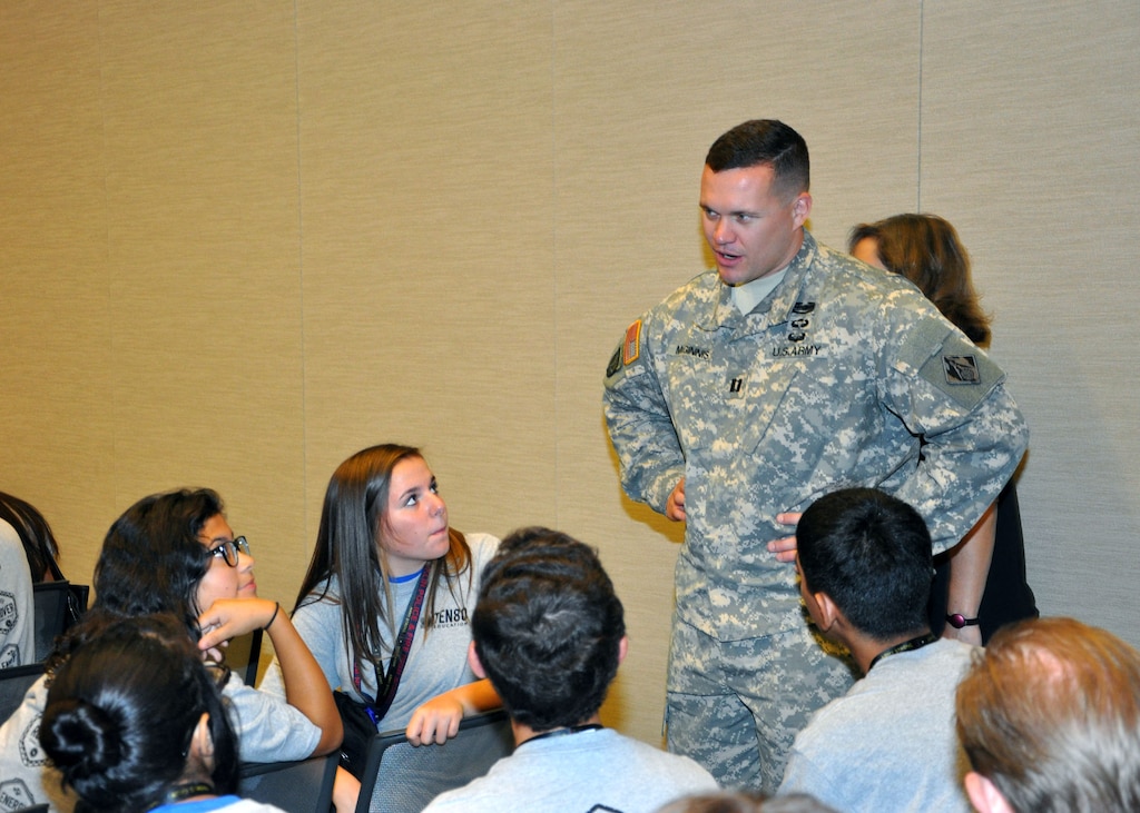Capt. Adam Z. McGinnis, the U.S. Army Corps of Engineers Los Angeles District’s deputy area engineer for the Arizona-Nevada Area Office, speaks with a group of students from Phoenix area schools during a Science Technology Education and Math event held Sept. 25 at the Phoenix Convention Center by Ten80 Education. The event was one of ten expositions Ten80 held across the country in 2014 where students actively engage in workshops, demonstrations and a one-day points race for pride and prizes and both students and teachers could evaluate the National STEM League curriculum, collaborative network and optional competition league. 