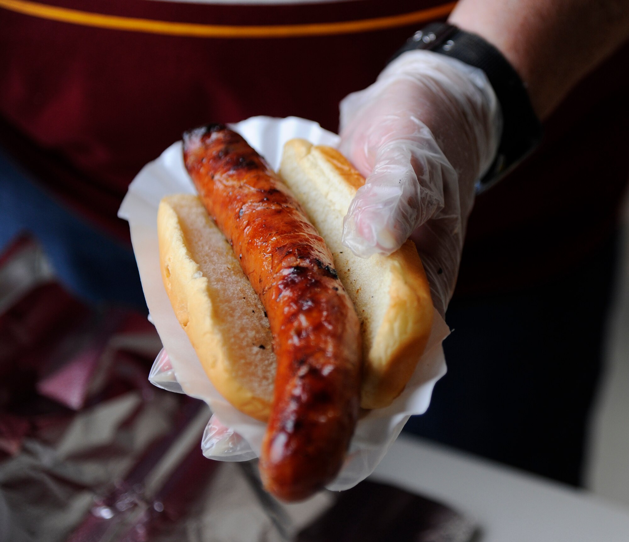 A “Fred Stokes Sausage” is prepared for a customer during Retiree Appreciation Day at the Base Exchange on Hurlburt Field, Fla., Sept. 25, 2014. The event included various activities, such as free blood pressure checks, sidewalk sales, and a meet and greet with former NFL player Fred Stokes. (U.S. Air Force photo/Staff Sgt. Sarah Hanson)