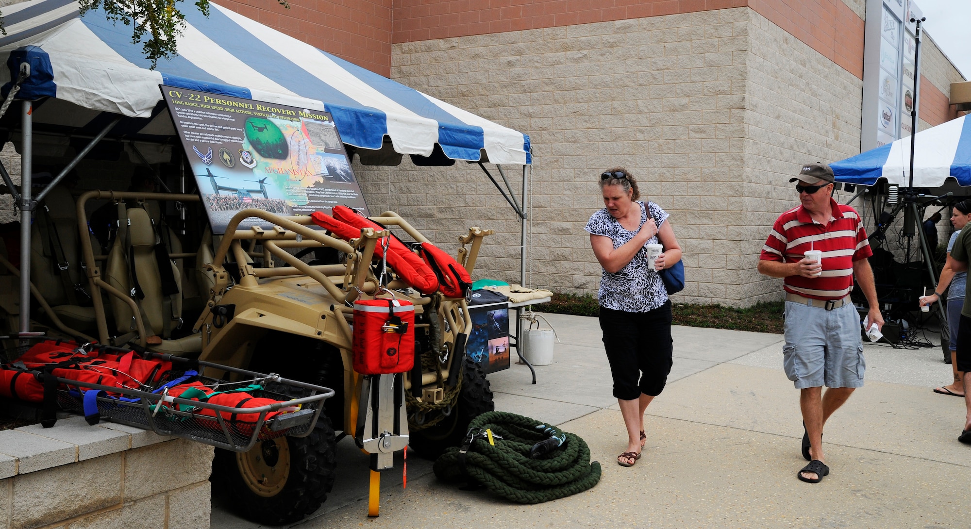 Lisa and Matt Poole, take a look at a military display during Retiree Appreciation Day at the Base Exchange parking lot on Hurlburt Field, Fla., Sept. 25, 2014. Various units from the 1st Special Operations Wing set up informational booths to give participants a better understanding of Hurlburt’s mission. (U.S. Air Force photo/Staff Sgt. Sarah Hanson)