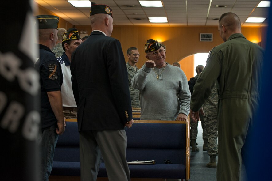 Col. Brook Leonard, 51st Fighter Wing commander, chats with members from the Veterans of Foreign Wars organization after a Prisoners of War/Missing in Action remembrance ceremony Sept. 25, 2014, at Osan Air Base, Republic of Korea. Team Osan observed a POW/MIA memorial week with the remembrance ceremony, a reveille and retreat ceremony, and a 24-hour run. (U.S. Air Force photo by Staff Sgt. Jake Barreiro/Released)