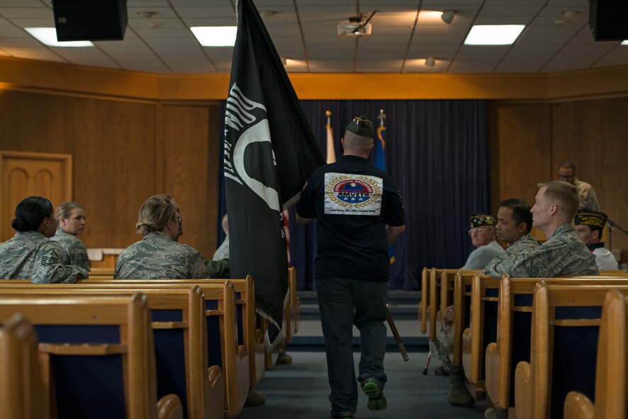 A member of the Veterans of Foreign Wars prepares to place the Prisoners of War/Missing in Action flag on the podium during a POW/MIA remembrance ceremony Sept. 25, 2014, at Osan Air Base, Republic of Korea. POW/MIA remembrance day is traditionally observed on the third Friday of September, but Team Osan held a POW/MIA remembrance week Sept. 19 - Sept. 26. (U.S. Air Force photo by Staff Sgt. Jake Barreiro/Released)