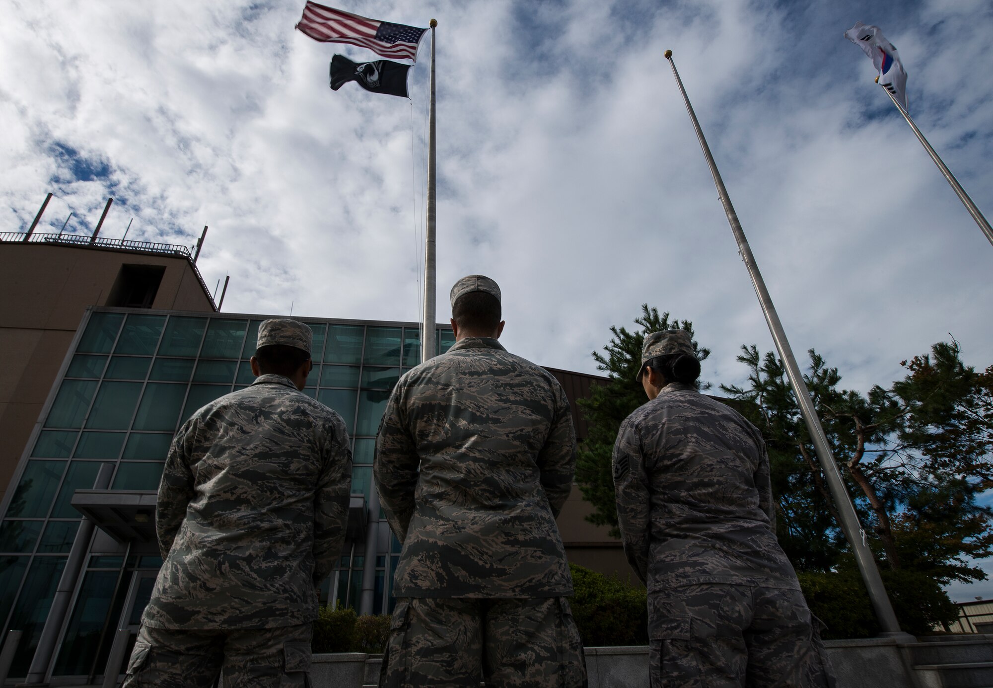 Team Osan stands by before a retreat ceremony Sept. 24, 2014, at Osan Air Base, Republic of Korea. The retreat ceremony was in honor of Prisoners of War and Missing in Action. POW/MIA remembrance day is traditionally observed on the third Friday of September each year. There are more than 8,000 American POW/MIAs from the Korean War. (U.S. Air Force photo by Staff Sgt. Jake Barreiro/Released)