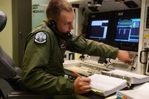 Capt. Dan Hejde, 12th Missile Squadron combat missile crew commander, performs a simulated inhibit test in the missile procedures trainer during a training session at Malmstrom Air Force Base Sept. 24. While training for the 2014 Global Strike Challenge, Hejde and his teammate performed various procedures that missileer teams must perfect in order to accomplish their mission. (U.S. Air Force photo/Airman 1st Class Collin Schmidt)