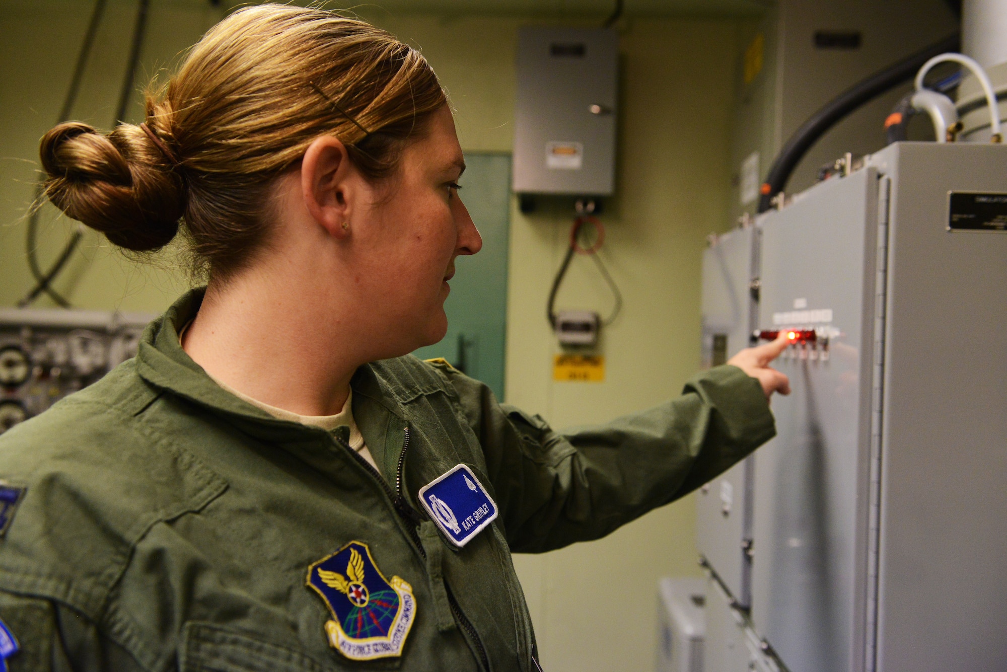 Capt. Katie Grimley, 10th Missile Squadron combat missile crew commander, performs an emergency air condition unit checkout in the missile procedures trainer during a training session at Malmstrom Air Force Base Sept. 24. The checkout confirms the equipment is operational and was part of a training session in preparation for the 2014 Global Strike Challenge. (U.S. Air Force photo/Airman 1st Class Collin Schmidt)