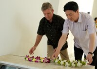 Gen. Hawk Carlisle, Pacific Air Forces commander (left), and Lt. Gen. Huang Guoxian (right), commander Nanjing Military Regional Air Force Command, lay wreaths to pay respect to the men and women lost in the attack on Pearl Harbor.  Carlisle hosted Huang and a delegation of People's Liberation Army Air Force officers as part of a reciprocal visit key to building a strong military to military relationship between the U.S. and China. (U.S. Air Force photo by Tech. Sgt. James Stewart/Released)