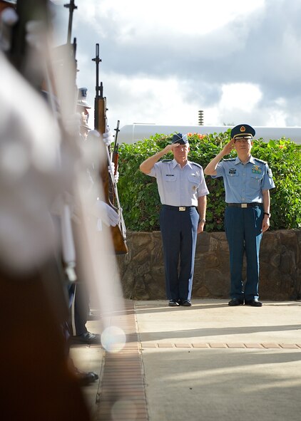 Gen. Hawk Carlisle, Pacific Air Forces commander (left), and Lt. Gen. Huang Guoxian (right), commander Nanjing Military Regional Air Force Command, render salutes before passing through an honor guard cordon, Sept. 23, 2014, Joint Base Pearl Harbor-Hickam, Hawaii.  Carlisle hosted Huang and a delegation of People's Liberation Army Air Force officers as part of a reciprocal visit key to building a strong military to military relationship between the U.S. and China. (U.S. Air Force photo by Tech. Sgt. James Stewart/Released)